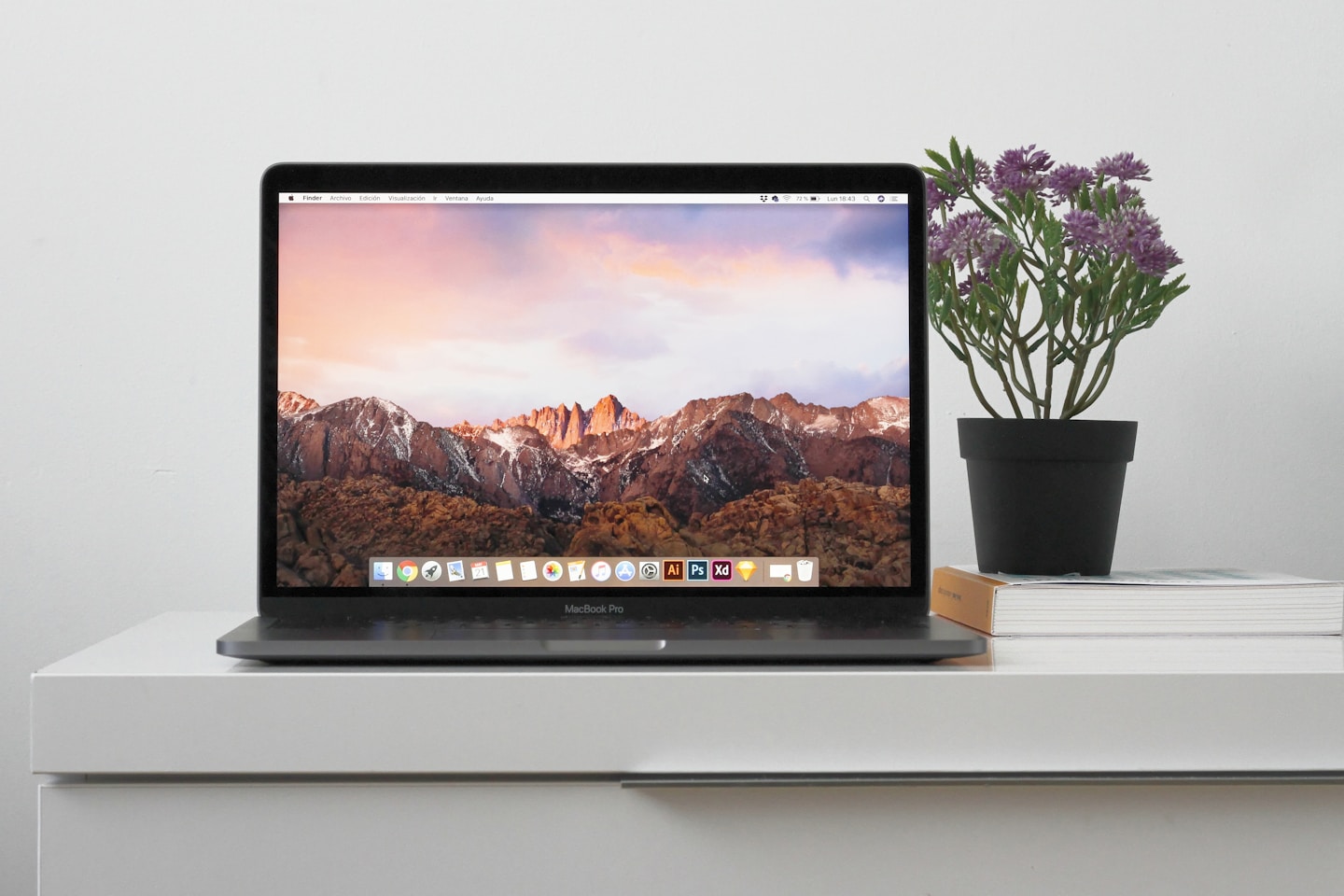MacBook on top white table