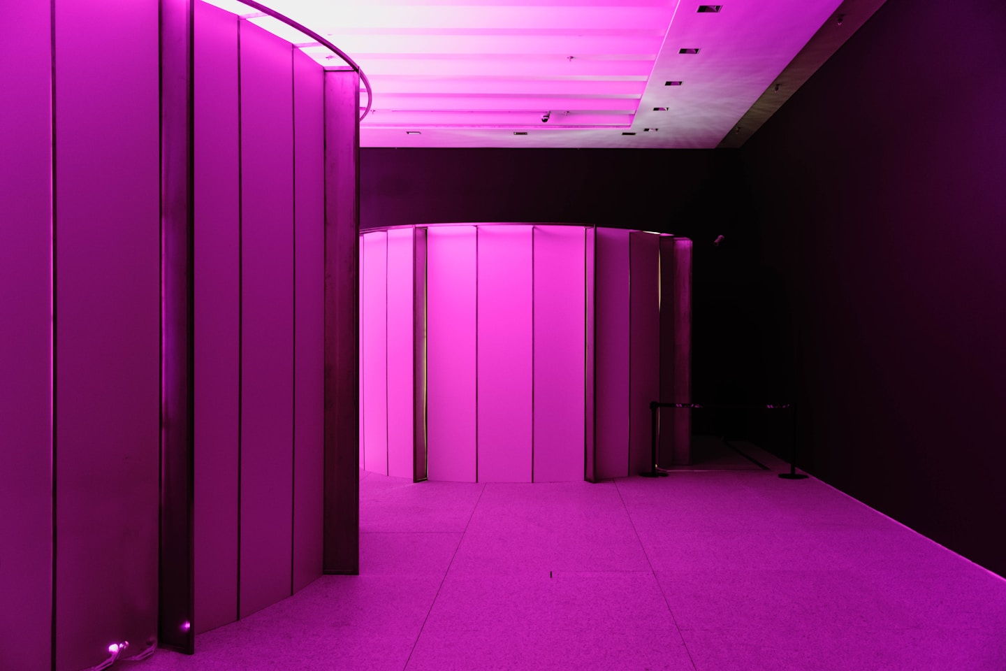 A long hallway with a purple light in the middle