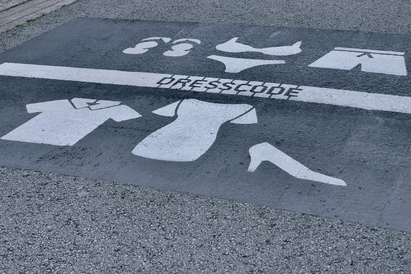Dresscode sign on the streets. Depending on what side of the line you are, you should me dressed less naked.