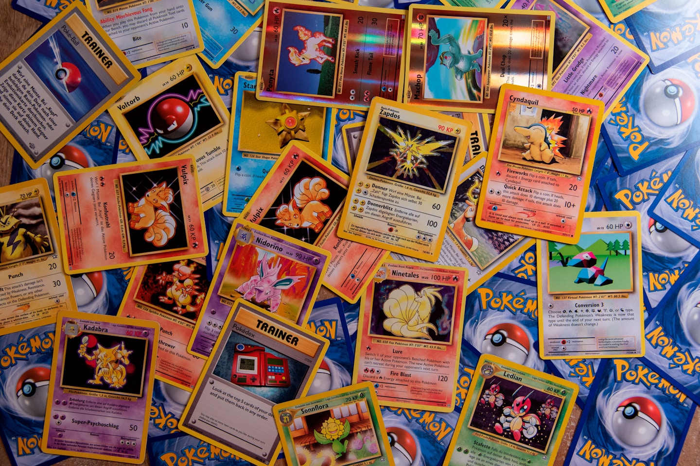 A bunch of Pokémon Trading Cards with Zapdos, Ninetales, Porygon, Cyndaquil, Ponyta, Machop, Vulpix and many more.